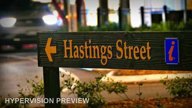 Hastings Street Sign with Night Traffic Behind