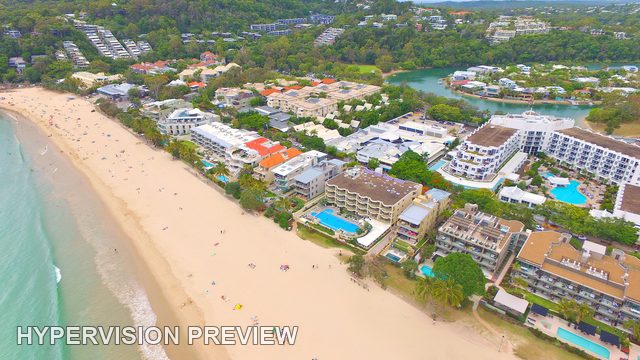 Main Beach Buildings Beneath Wooded Hills