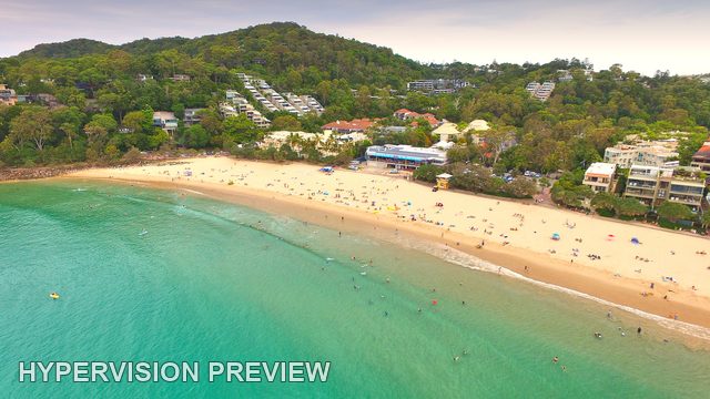 Main Beach Below Green Coastal Slopes