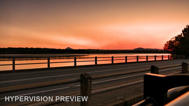 Warm Sunset Beyond a Waterside Road