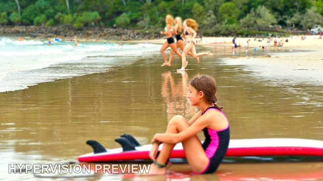 Young Surfer Resting Beside a Red Board