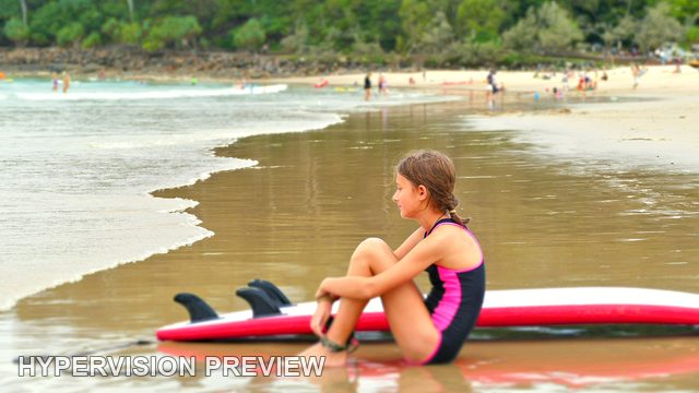 Side View of a Young Surfer at the Water Edge