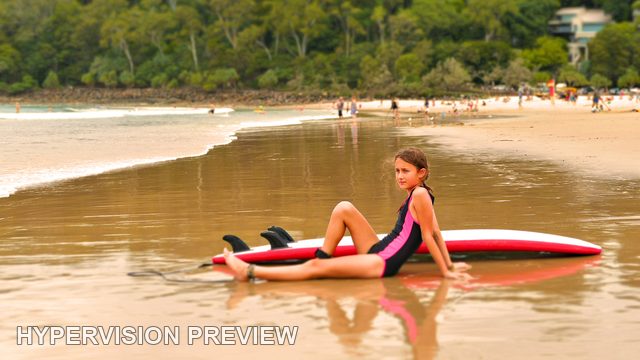 Young Surfer Looking Back from a Red Board — Warm Edit