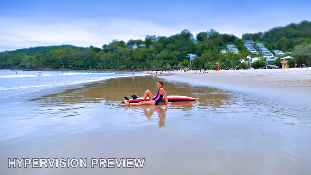 Young Surfer Reflected in Wide Beach Shallows