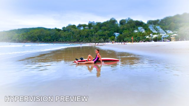 Young Surfer Reflected in Wide Beach Shallows — White Vignette Edit