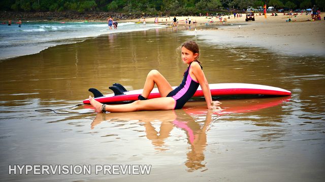 Young Surfer and Board in Reflective Water