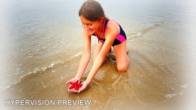 Child Examining a Red Starfish-Shaped Object — White Vignette Edit