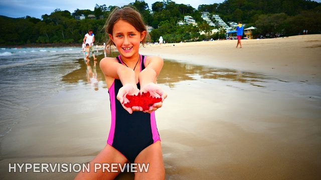 Child Presenting a Red Starfish-Shaped Object