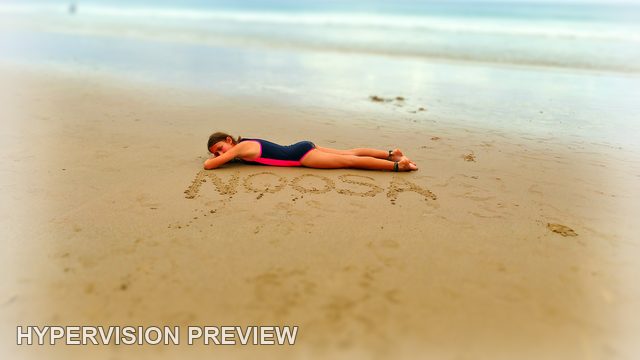 Child Resting Beside Noosa Writing in the Sand