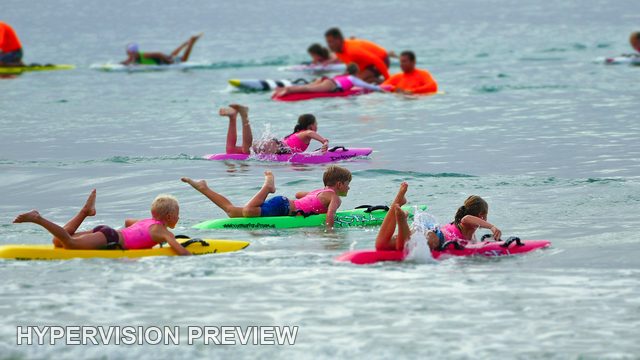 Board Riders Resting and Paddling Offshore