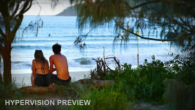 Two Beachgoers Resting in Coastal Shade