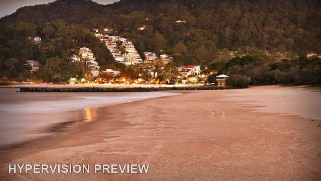 Soft Surf Beside a Warm Coastal Hillside
